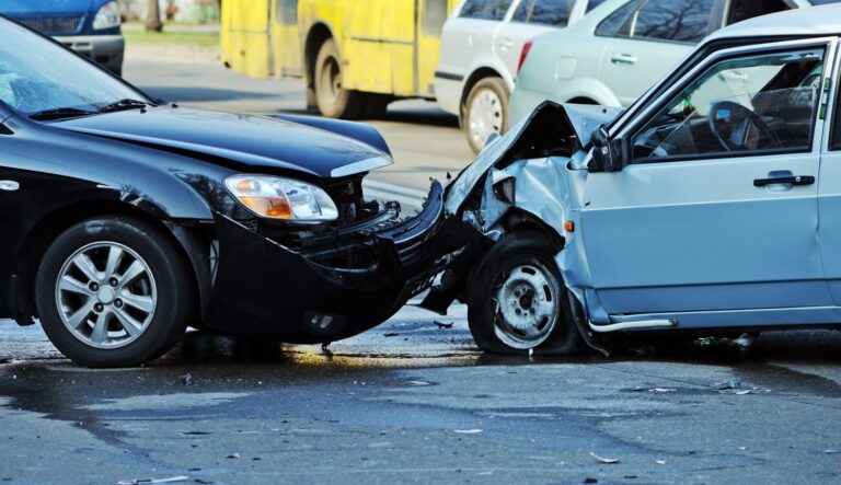 two cars crashed together both with front-end damage