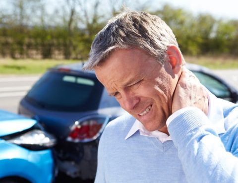 Man experiencing neck pain after a car accident