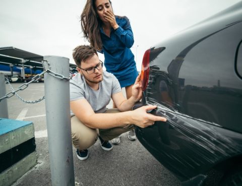 Man and Woman examining a car accident