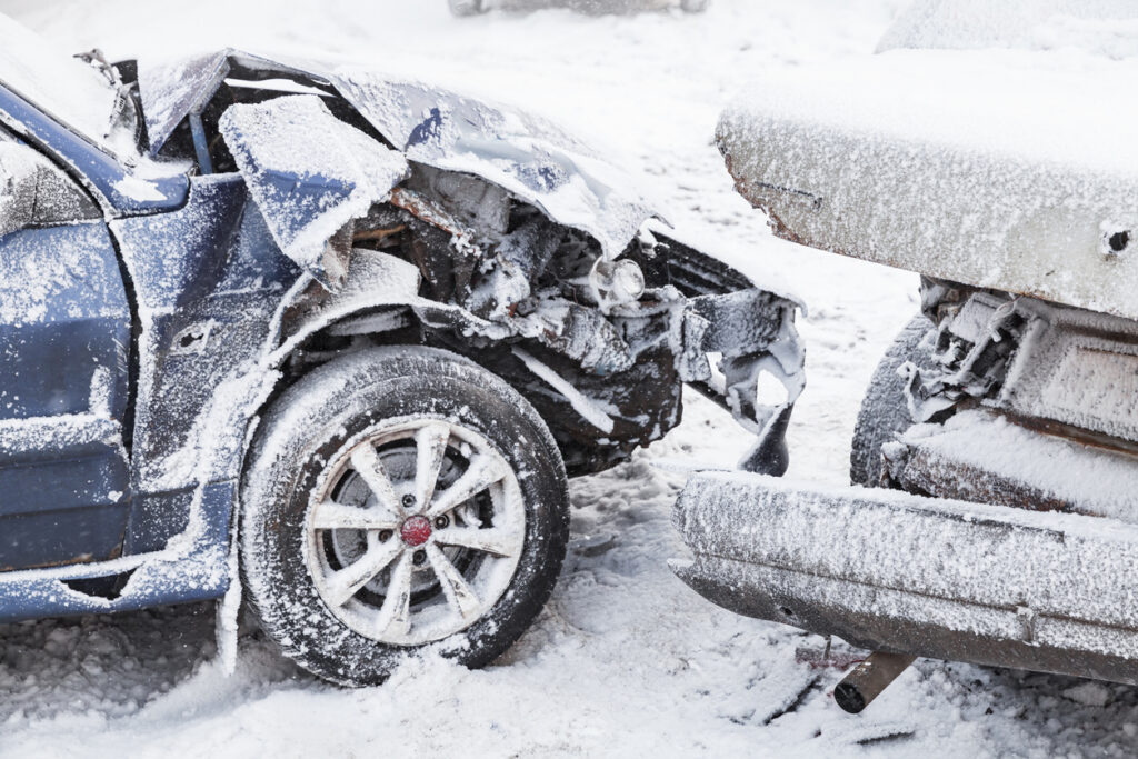 Crashed cars dusted in snow