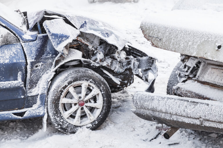 Crashed cars dusted in snow
