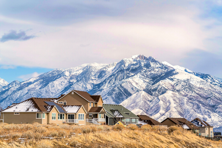 Homes with solar panels on roof against magnificent snowy Wasatch Mountain view