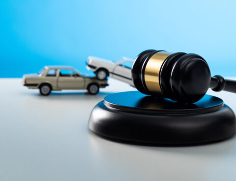 Gavel and model car on the table.